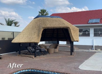 The same poolside lapa after re-thatching, with a fresh, neatly finished domed thatch roof.